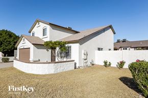 Glendale house for rent - a white house with a yard and a fence