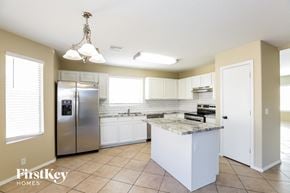 Glendale house for rent - a kitchen with white cabinets and a stainless steel refrigerator