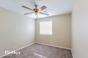 Glendale house for rent - a bedroom with a ceiling fan and a carpet
