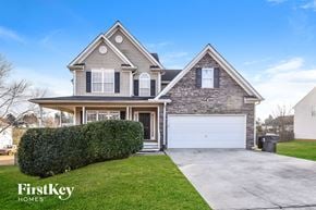 Douglasville house for rent - a house with a white garage door on a driveway