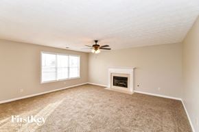 Douglasville house for rent - a living room with a fireplace and a ceiling fan