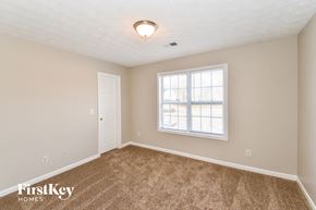 Douglasville house for rent - a bedroom with carpet and a window and a door