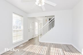 O'fallon house for rent - A spacious room with a staircase leading to the second floor.