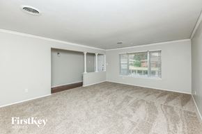 Fort Worth house for rent - A room with a carpeted floor and a window with blinds.