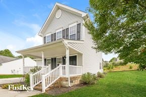 Kernersville house for rent - A house with a porch and a tree in front of it.
