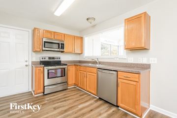 Kernersville house for rent - A kitchen with wooden cabinets and a stainless steel dishwasher.