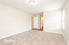 Kernersville house for rent - A spacious room with a carpeted floor and a doorway leading to another room.