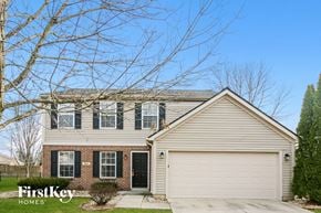 Avon house for rent - a home with a white garage door and a brick house