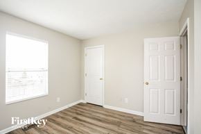 Avon house for rent - a bedroom with two doors and a window and a wood floor