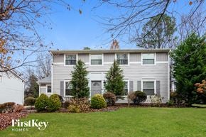 Charlotte house for rent - a white house with a lawn and trees in front of it
