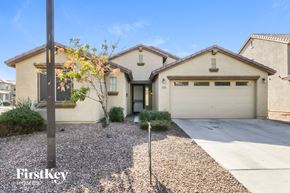 San Tan Valley house for rent - a beige house with a white garage door and a gravel driveway