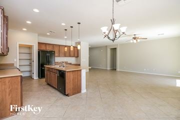 San Tan Valley house for rent - an open kitchen and living room with an island and a black refrigerator