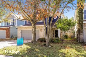 San Antonio house for rent - a blue chair in a yard in front of a house