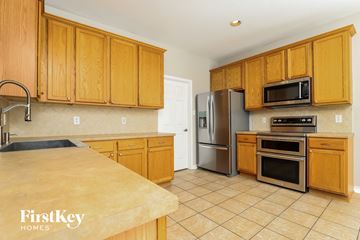 San Antonio house for rent - a kitchen with wooden cabinets and stainless steel appliances