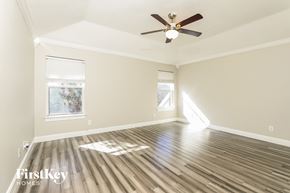 San Antonio house for rent - a living room with wood floors and a ceiling fan