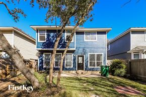 San Antonio house for rent - a blue and white house with a yard and trees