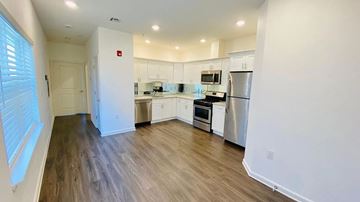 Elizabeth apartment for rent - a kitchen with white cabinets and stainless steel appliances