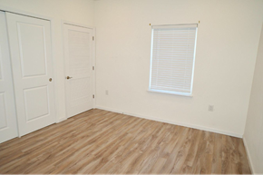 Elizabeth apartment for rent - a bedroom with white walls and wood floors and a window