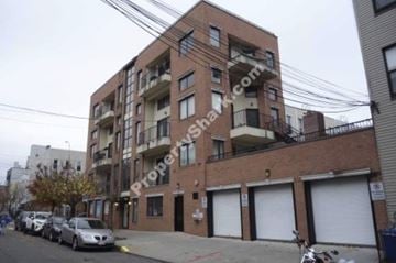 Brooklyn apartment for rent - A brick building with a balcony on the second floor.