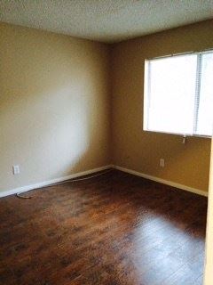Northridge apartment for rent - an empty room with a window and wooden floors