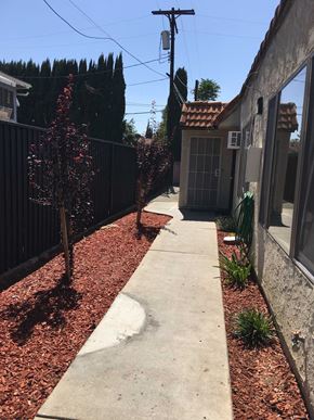 Northridge apartment for rent - a sidewalk in front of a fence and a house