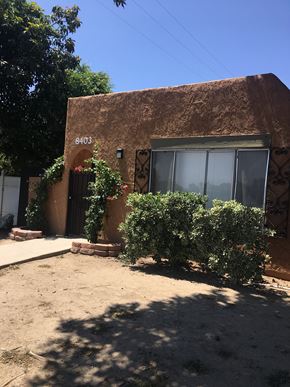 Northridge apartment for rent - a building with a door and bushes in front of it