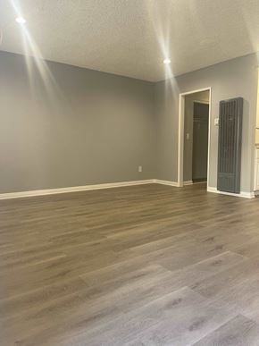 Northridge apartment for rent - a living room with wood floors and gray walls and a radiator