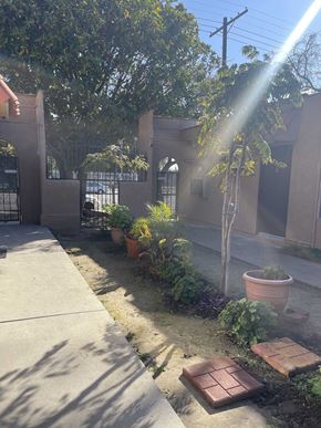 Northridge apartment for rent - the front yard of a house with a garden and a ray of sunshine