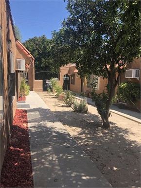 Northridge apartment for rent - a sidewalk next to a building with trees