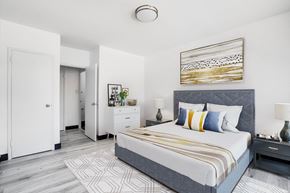Toronto apartment for rent - a bedroom with a large bed and a white closet