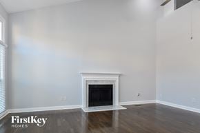 Greensboro house for rent - a living room with white walls and a fireplace