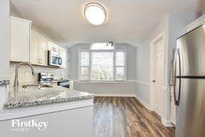 Greensboro house for rent - a kitchen with white cabinets and a counter top