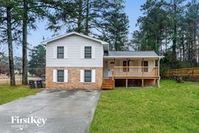 Snellville house for rent - a white house with a porch and a driveway
