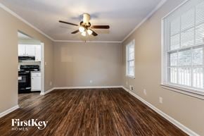 Snellville house for rent - an empty living room with wood flooring and a ceiling fan