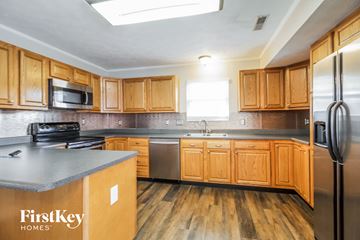 Loveland house for rent - a kitchen with wooden cabinets and stainless steel appliances