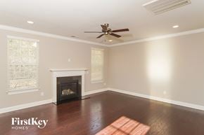 Kernersville house for rent - a living room with a fireplace and a ceiling fan