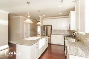 Kernersville house for rent - a white kitchen with granite counter tops and white cabinets