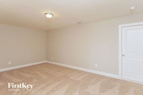 Kernersville house for rent - a bedroom with beige carpet and a white door