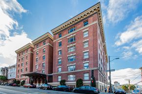 San Francisco apartment for rent - A large red brick building with a blue sky in the background.