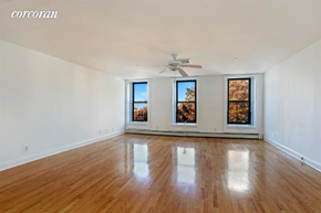 Brooklyn apartment for rent - A room with wooden floors and a ceiling fan.
