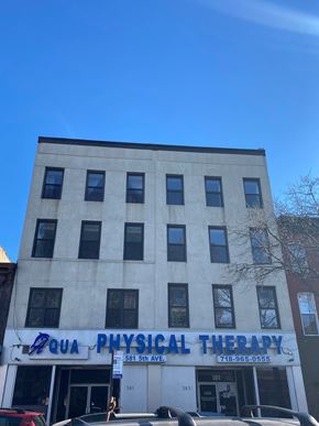 Brooklyn apartment for rent - A building with a sign that says "QUA PHYSICAL THERAPY".