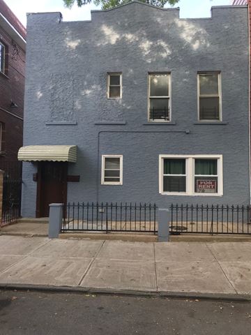 Brooklyn apartment for rent - a blue building with a fence in front of it