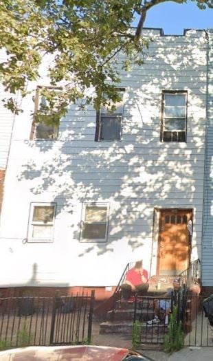 Brooklyn apartment for rent - a white building with a tree shadow on it
