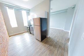 Toronto apartment for rent - an empty room with a refrigerator in the middle