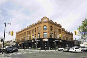 Toronto apartment for rent - a large brick building on the corner of a city street