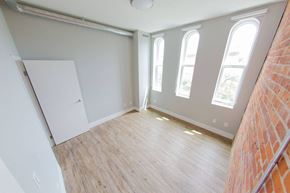 Toronto apartment for rent - an empty room with a wood floor and windows