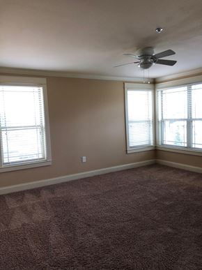 Odessa apartment for rent - a living room with a ceiling fan and two windows