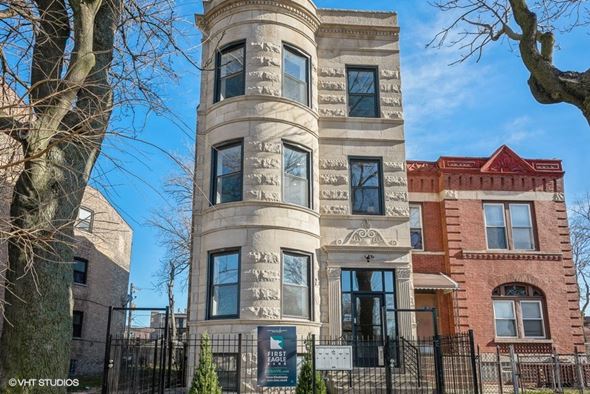 Chicago apartment for rent - a tall building with a fence in front of it