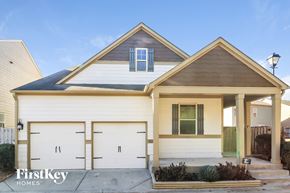 Cumming house for rent - the front exterior of a home with white garage doors