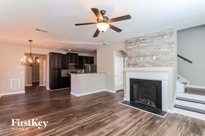 Cumming house for rent - a living room with a fireplace and a kitchen